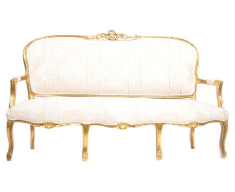 A 19th Century French giltwood framed sofa settee canape. Carved decorative top rail with scrolled arms set with cushioned el