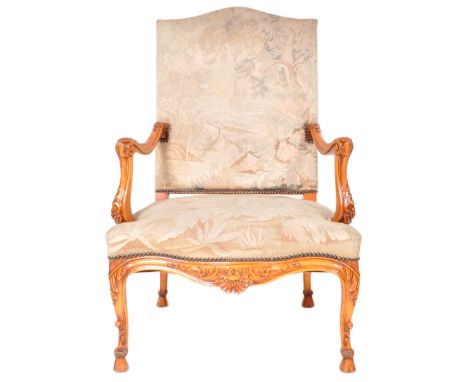 A 19th Century French tapestry fauteuil armchair / throne chair having a padded back and seat rest with floral tapestry uphol