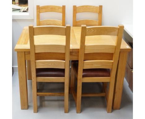 LIGHT OAK DINING TABLEwith pull apart action and concealed leaf, standing on block supports, together with six matching ladde