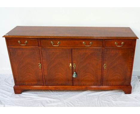 MAHOGANY AND CROSSBANDED SIDEBOARDthe moulded top above three frieze and cockbeaded drawers with four cupboard doors below, s