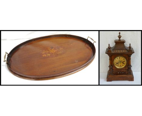 19th CENTURY OVAL MAHOGANY TRAYwith a raised side and two brass carrying handles, with a central inlaid flower motif, 64cm wi
