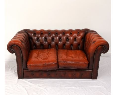 CHESTERFIELD BROWN LEATHER SOFAwith button back and arm detail and decorative metal stud work, on bun feet, 150cm wide 