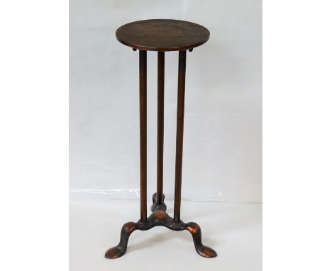 EDWARDIAN GILT METAL ADJUSTABLE TORCHEREwith a circular top supported by three columns on pad feet, 74cm high extended; and a