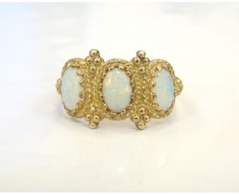 OPAL THREE STONE RINGwith rope twist and ball decorated setting, in nine carat gold, ring size L