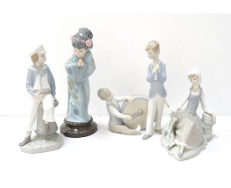 FOUR LLADRO FIGURESa Japanese woman in traditional dress, 26cm high, a young boy seated on a mooring post holding a pond yach