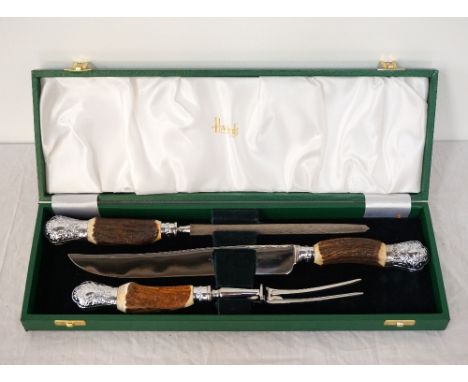 'HARRODS' CASED CARVING SETcomprising a carving knife, fork and steel, all with horn handles