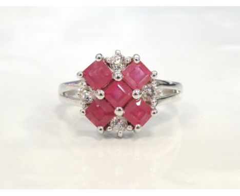 RUBY AND CZ CLUSTER RINGon nine carat white gold shank with decorative split shoulders, ring size M-N