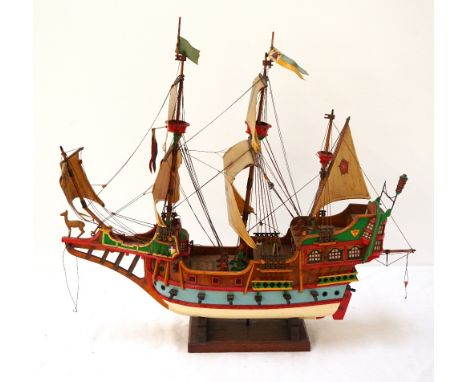 DETAILED MODEL OF THE GOLDEN HINDin full sail with rigging and gun ports raised, on stand, with a black and white photograph 
