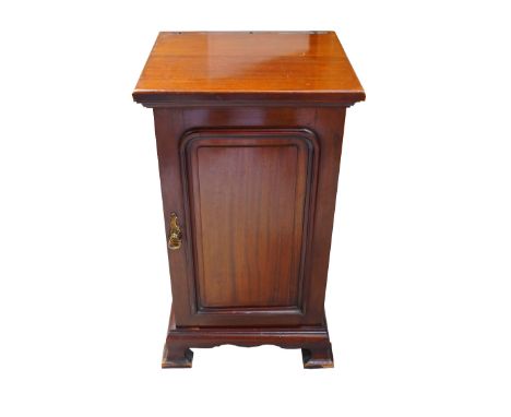 MAHOGANY BEDSIDE CABINETthe square top above a panelled door, standing on bracket feet, 77cm high 