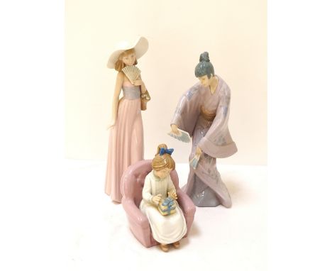 THREE NAO/LLADRO FEMALE FIGURESGirl wearing hat and holding fan, 32cm high, Japanese girl wearing traditional dress and danci