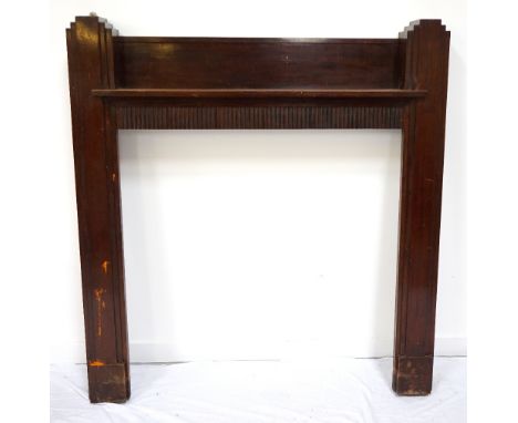 ART DECO STAINED OAK FIRE SURROUNDwith step decorated outer columns flanking a sunken shelf above a carved frieze, 139cm x 13