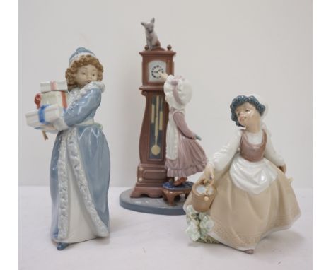 LLADRO FIGURE GROUPof a young girl standing on a stool adjusting hands on a longcase clock (with cat sat on top), 27.8cm high