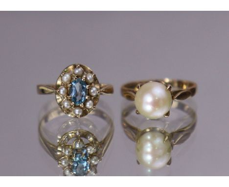 A 9ct gold ring set oval-cut pale blue stone within a seed-pearl border, size: K (2gm); &amp; a 9ct. gold ring set cultured p