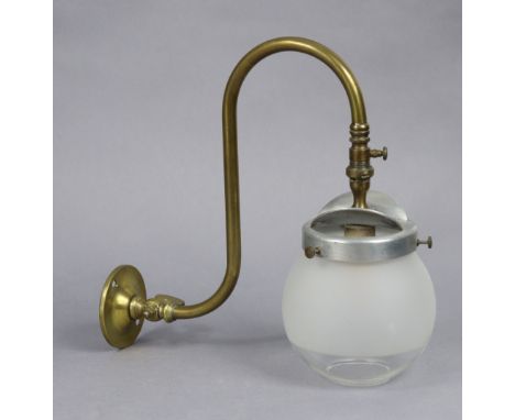 An Edwardian brass wall-mounted gas lamp with a glass globular shade, 26cm high. 