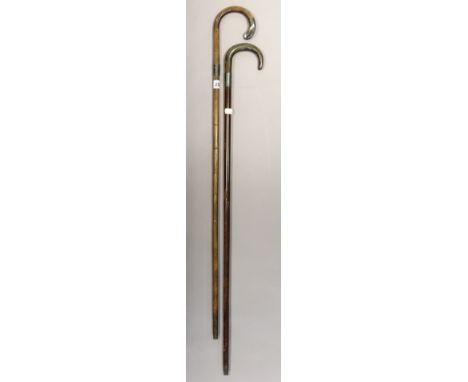 Two vintage gent’s walking canes, each with silver mounts, both 93cm high. 