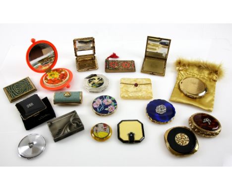 A collection of vintage compacts to include an Art Deco black and cream compact, a French Compact the cover decorated with a 