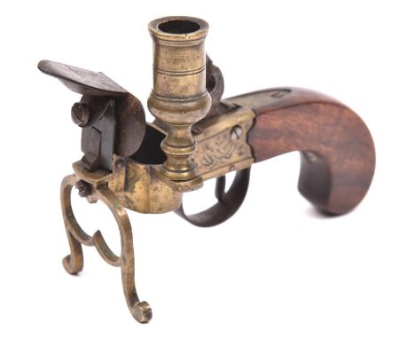 An early 19th century brass framed flintlock tinder lighter/candle holder, 5½" overall, engraved with trophy of flags etc., w