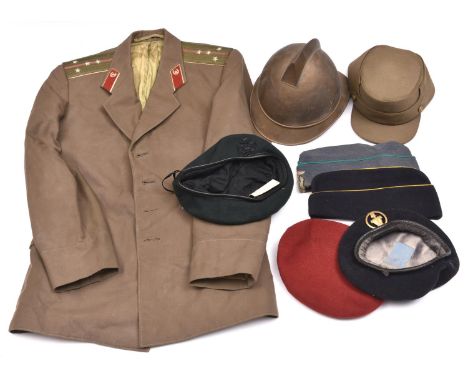 A continental fireman's brass helmet, (skull slightly perished), a Spanish kepi; a Russian officer's tunic; a beret of The Rh