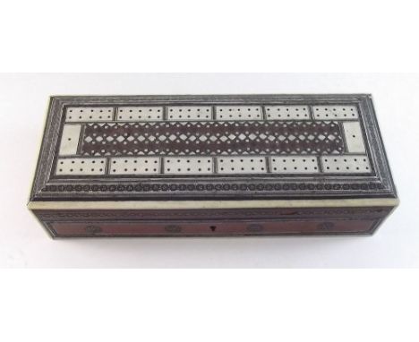 An Indian bone and inlaid vizagapatum games box with cribbage board to top and contents of bone dominoes