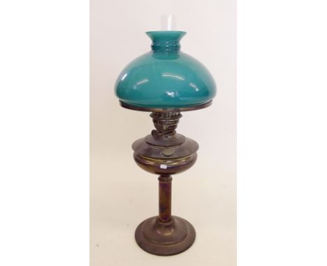 A Victorian glass oil lamp with green shade and Duplex burner