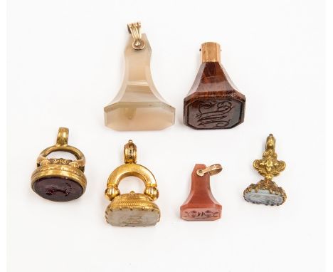 A collection of six antique seals in unmarked yellow metal and gilt metal,&nbsp; some set with glass and hard stones, to incl