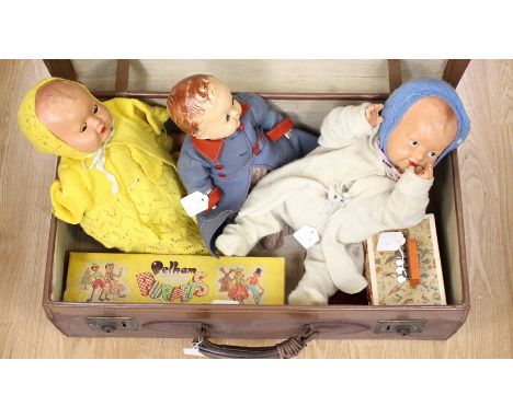A suitcase to include; a Pinocchio Pelham Puppet, boxed, three dolls from the late 1940's and a children's accordion/squeeze 