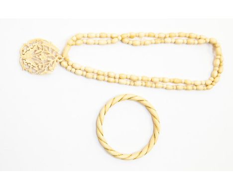 A 1920's ivory with gold wire bangle and an ivory pendant (2)