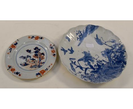 **AWAY MERGE** An 18th Century porcelain plate decorated in an Oriental style with cobalt blue and iron red, the outer border