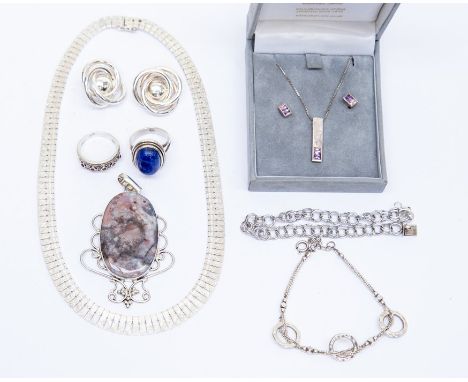 A collection of silver and white metal jewellery to include a large jasper set pendant with scrolling surround, a lapis lazul