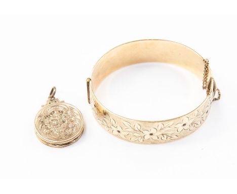 A 9ct rolled gold bangle set with red stones; and a Victorian rolled gold locket (2)