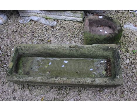 An 18th Century carved stone trough; a similar demi lune trough (af) (2)