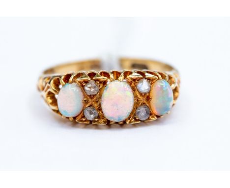 A Victorian 18ct gold opal and diamond ring, comprising three oval opals with diamond set accents, size M, total gross weight