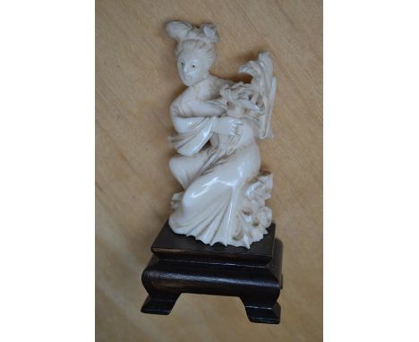 Japanese ivory figure of a Geisha on wooden stand approx 10 cms high