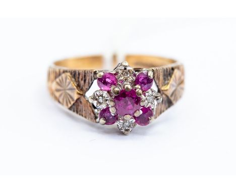 A 9ct gold ruby and diamond cluster ring, engraved detail to shoulders, size O, total gross weight 4grms