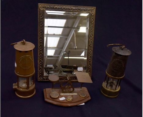Two vintage brass miners lamps, Victorian postal scales and brass mirror