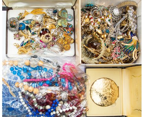 A large collection of costume jewellery to include vintage paste set brooches, enamel bird brooches, white and gilt metal met