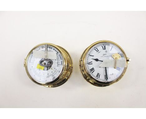 A Schatz Royal marine ships clock together with a Schatz ships barometer, both are brass bound and hinged bezels