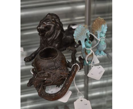 A Japanese antimony vase encircled by a dragon; a spelter resting lion, bronzed; two Bidri stylised peacocks (4)