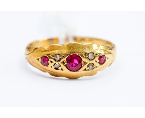 A Victorian ruby and diamond 18ct gold ring, three round cut rubies set with diamond accents in between, size L, total gross 