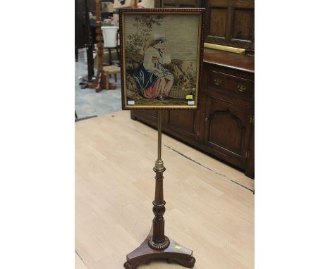 An early Victorian tapestry framed polescreen circa 1860, a brass pole supporting an oak frame with beaded decoration with a 