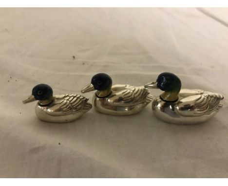 A trio of silver and enamel mallards