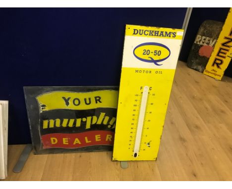 An enamel 'Duckhams Motor Oil' sign; together with a glass 'Your Murphy Dealer' sign