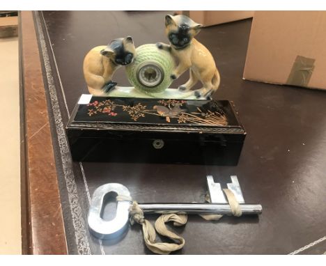 A Japanese lacquered box; together with a ceramic cat clock, large key and crowns