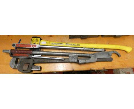 Two torque wrenches, a very large adjustable Stilson wrench and an axe