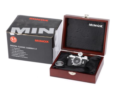 A Minox DCC Leica M3 Digital Camera a miniature reproduction of a Leica M3 rangefinder camera, with charger, cable, paperwork