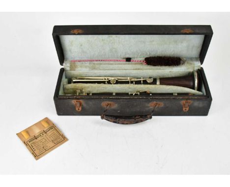 A cased clarinet, with spare reeds.