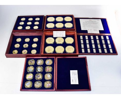 Four case sets of gold-plated commemorative coins, comprising a set of twelve proof 'British Banknotes', a set of twenty-four