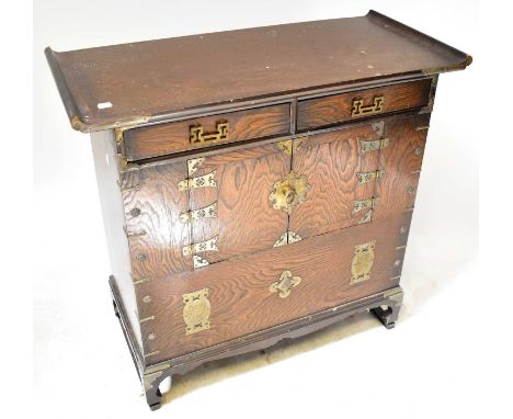 A Korean elm morijang cabinet, with an arrangement of two drawers and a pair of cupboard doors, on bracket feet with metal mo