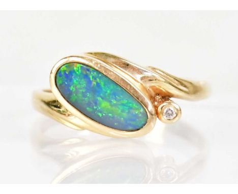 A 14ct yellow gold ring set with a boulder opal and small diamond, size Q, approx. 2.7g, indistinctly stamped '585'.