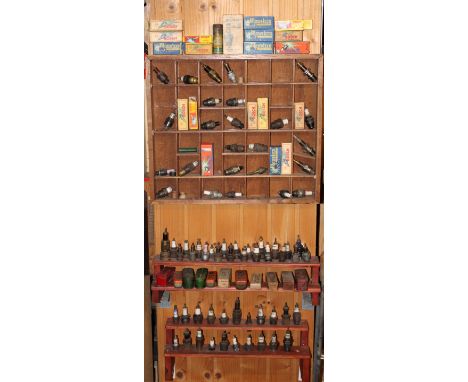 A collection of sparkplugs and related tins and boxes,including Bosch, Champion, Beru, NGK, Oleo, First American, Lodge, KLG,